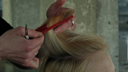 closeup of hairdresser cutting hair.