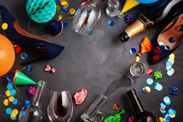 Top view shot of after a party celebration with empty bottles,wine glass, girl shoes and party accessories