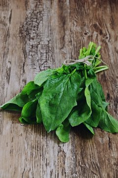 Fresh spinach isolated on wooden background
