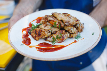 Chicken skewers on a plate with sauce