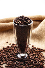 Coffee beans in a glass beaker