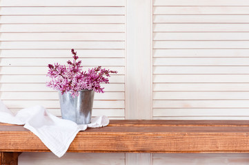 Lilac bouquet on the wooden shelf