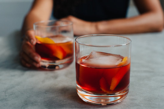 Couple sharing negronis at the kitchen table