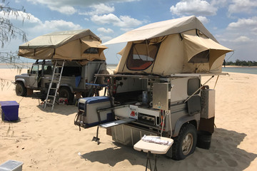beach camping set up with roof top tents