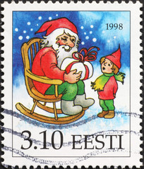 Gnome and child on Christmas postage stamp of Estonia