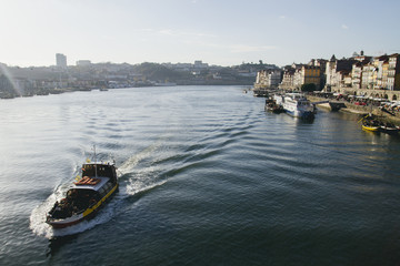 Naklejka premium Touristic boat in the Douro River in Oporto, Portugal