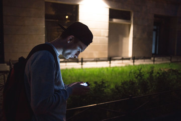 Young male in the city messaging on his smartphone