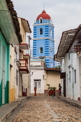Cobbled street in Sancti Spiritus, Cuba. The Parroquial Mayor church in the background.