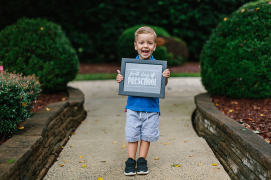 Cute Young Boy Holding Up A First Day Of Preschool Sign