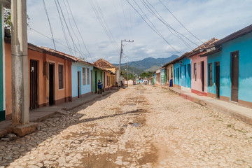 Fototapeta na wymiar TRINIDAD, CUBA - FEB 8, 2016: View of a cobbled street in the center of Trinidad, Cuba.