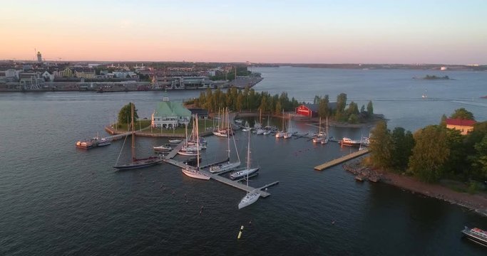 Helsinki archipelago, C4K aerial view of valkosaari island, in the south harbor bay, on a sunny summer evening dusk, in Helsingfors, Uusimaa, Finland