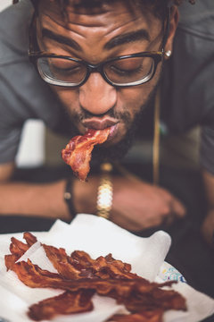 Man With Glasses Eating Bacon 