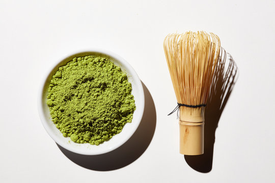 Bamboo whisk and bowl of Matcha powder.
