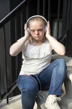 A young adult listening to music