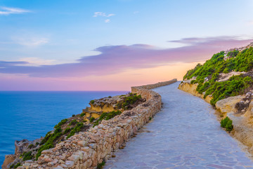 Seaside path stretched alongside Ta Cenc cliffs on Gozo, Malta