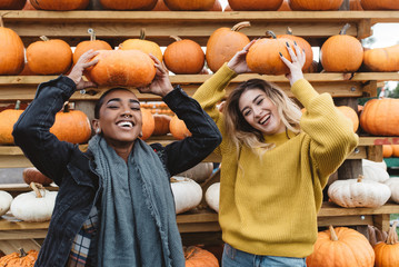Two best friends in their twenties at a pumpkin patch