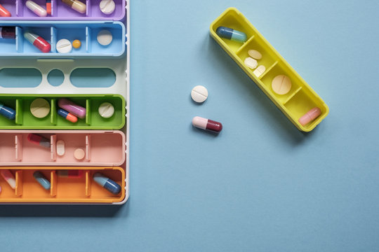 Colorful Case With Pills And Tablets On The Blue Background