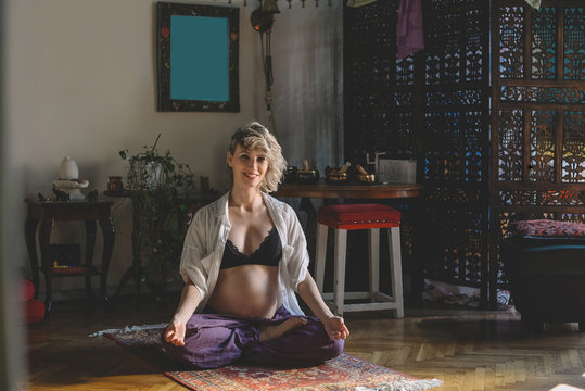 Pregnant Woman Sitting in a Meditation Pose