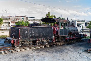 Fototapeta na wymiar Old steam engine at a train station in Cienfuegos, Cuba.