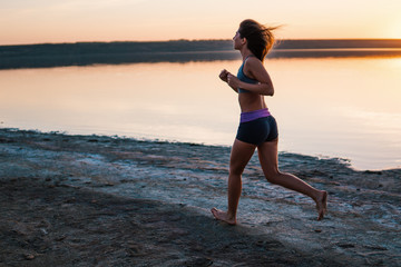 Woman Running on the Beach at Sunset.