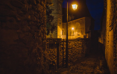 Fototapeta na wymiar Castle street by night lit by lamps