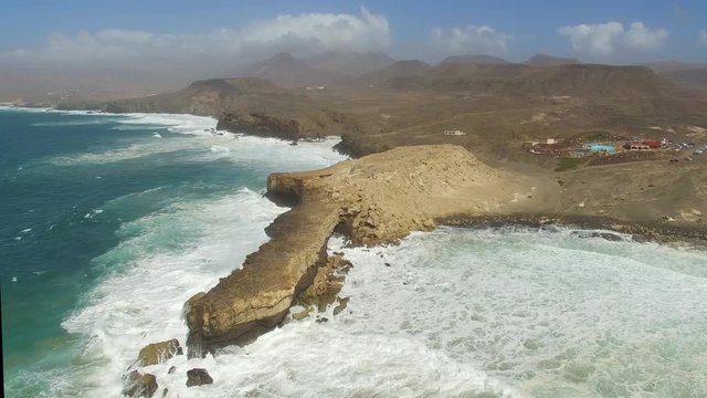 Aerial view of waves crashing of the rocks of punta Guadalupe in Fuerteventura.