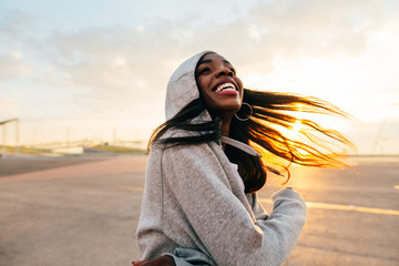 Young dancer having fun in the city at sunrise.