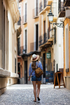 Woman doing tourism with map at Granada, Spain.