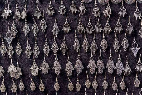 Fatima hands jewelry assortment in a souk market