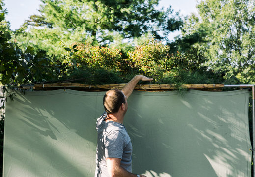Sukkot: Man Covers Roof Of Sukkah With Branches