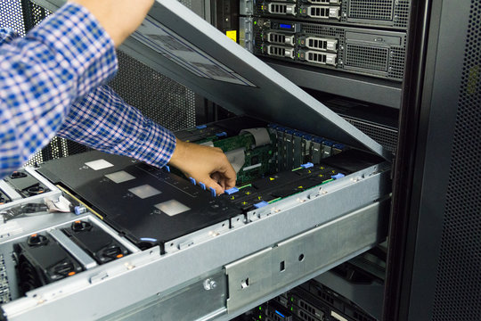 Technician working inside a server in a server room