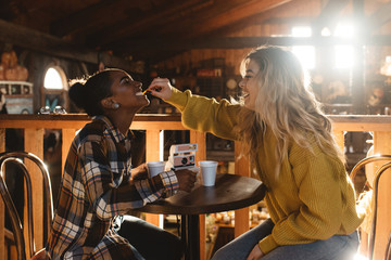 Two friends drinking apple cider on an autumn day