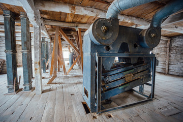 Inside old abandoned wooden mill with old equipment