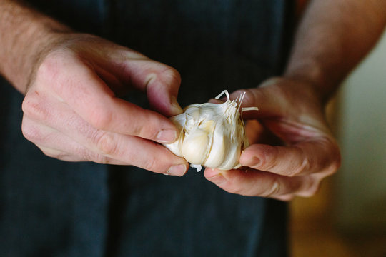 Man Peeling Garlic