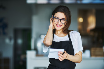 pretty waitress ready to take order on notepad in restauran