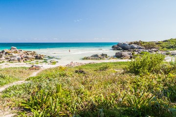 TULUM, MEXIO - FEB 29, 2016: Tourists enjoy the Caribbean beach in Tulum, Mexico