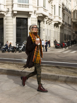 Woman on street with takeaway coffee