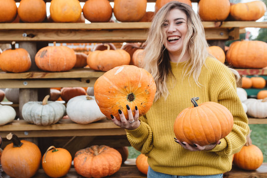 A young woman at a pumpkin patch