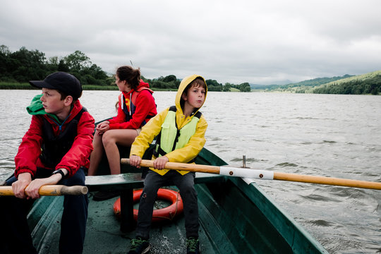 teens and kids on rowboat