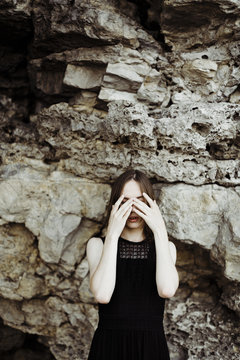 young androgyne man hide face