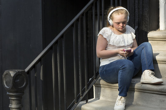 A young adult listening to music
