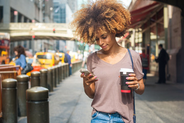 Young woman using phone outside Grand Central