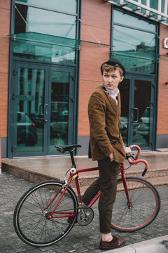 Young stylish guy with bicycle