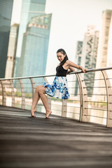 Beautiful Young Girl Dancing in the City, with background of skyscrapers 