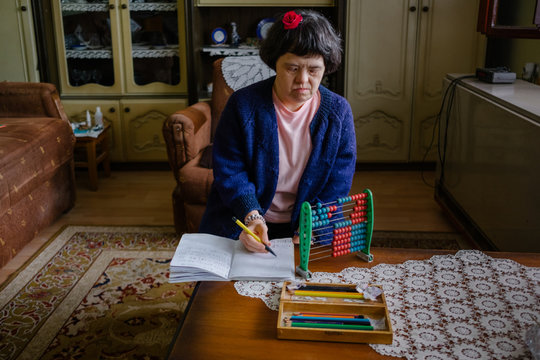 Female with down's syndrome having educational time at her home