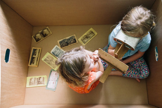 Sisters In A Cardboard Box with A Stereoscope