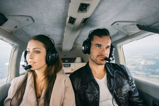 Handsome Stylish Caucasian Couple With Headsets Flying in Privat