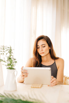 Charming girl with tablet at home