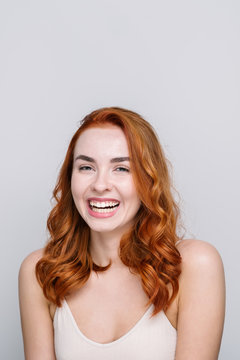 Studio Portrait Of Smiling Redhead Girl