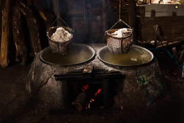 Traditional Salt making Pit-Bo Kluea District. Production of mountainous ,Salt (Sin-tao salt) Ancient salt making from underground water at Bo Kluea district, Nan Province, Thailand.